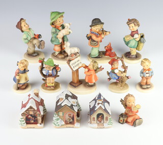 A Hummel figure - Shepherd's Boy 64 15cm, a ditto Puppy Love 1 12cm, Happy Traveller 109 12cm, girl with basket 377 11cm, girl sitting in a tree 147 9cm, a boy sitting on a tree 142 9cm (chipped), Scamp 558 9cm, Pixie 768 9cm, an angel blowing a horn 359 7cm and Bird Duet 169 10cm, 3 Hummel buildings - Village Bakery, Companies Coming, Candle Light Church and a miniature collectors plate - Feeding Time  
