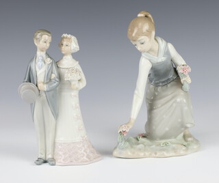 A Lladro group of a bride and groom 21cm (chipped flowers) and ditto of a girl picking flowers 21cm 