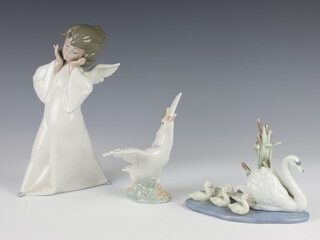 A Lladro figure of an angel 22cm, ditto of a goose 15cm and a group of swans 5722 15cm 