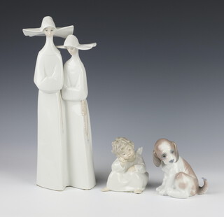 A Lladro figure of 2 nuns 34cm, a ditto of a seated angel 10cm together with a seated puppy 6210 12cm 