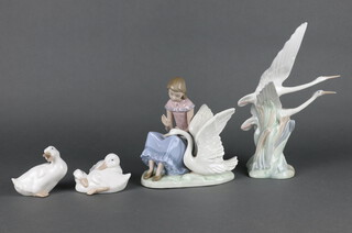 A Nao group of a young lady sitting with a swan 16cm, 2 goose groups 5cm and a pair of flying birds 30cm 