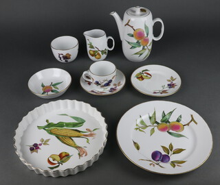 A Royal Worcester Evesham part tea and dinner service comprising coffee pot and lid, milk jug, 5 coffee cups, 5 saucers, sugar bowl, 8 dessert bowls, 9 small plates, 6 dinner plates, 2 oval dishes and a flan dish 
