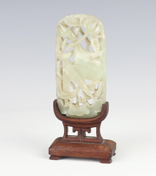 A Chinese carved and pierce jade plaque in the form of a standing exotic bird raised on a hardwood stand 13cm 