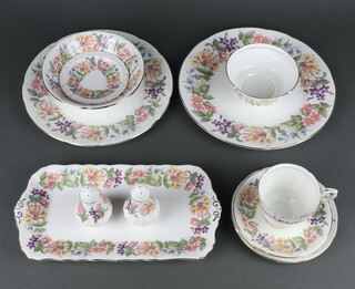 A Paragon Country Lane part tea and dinner service comprising 13 tea cups, 12 saucers (1 cracked), 12 small plates (1 cracked), 2 odd plates, 6 medium plates, 12 dinner plates, fruit bowl, sugar bowl, 2 milk jugs, 2 cake plates, an oval dish, salt and pepper, 2 sandwich plates, small dish, 17 soup bowls, 17 dessert bowls 