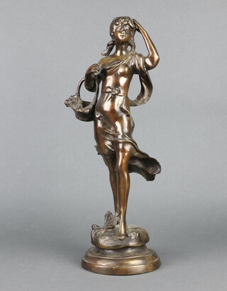 An Art Nouveau style bronze figure of a standing girl with basket raised on a circular base 43cm h x 14cm 