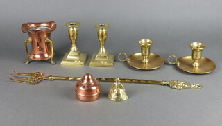 A 19th Century squat brass candlesticks raised on square bases 12cm h x 7cm, pair of brass chambersticks 7cm h, an Art Nouveau copper and brass vase with wavy border, raised on shaped feet 10cm h, a copper spirit burner, a brass toasting fork and a small brass Crinoline lady bell 
