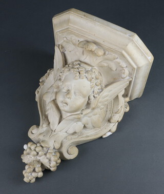 A 19th/20th Century plaster wall bracket in the form of a cherubs head with grape decoration 37cm x 22cm x 20cm 