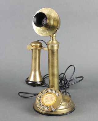 A reproduction brass candlestick telephone marked "The British Ericson London" 33cm x 13cm  
