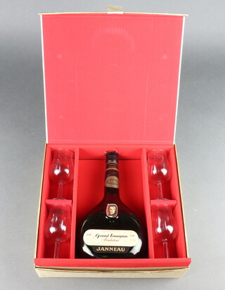 A 1970's bottle of Janneau Grand Armagnac contained in a presentation box with 4 glasses  