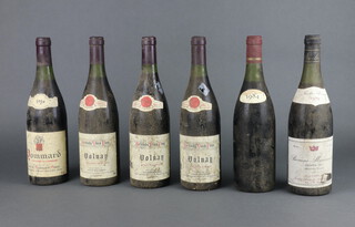 Three bottles of 1986 Grands Vin Volnay Leon Rigault, a bottle of 1979 Nicolas Seivant Beaune Marconnets Premier Cru (low on neck), a bottle of 1986 Pommard Veuve Aubert Aine and an unlabelled bottle of wine