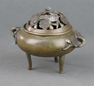 A Japanese bronze twin handled koro with pierced lid and floral decoration 8cm x 9cm 