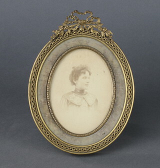 A 19th/20th Century pierced gilt metal oval easel photograph frame with swag decoration 20cm x 15cm 