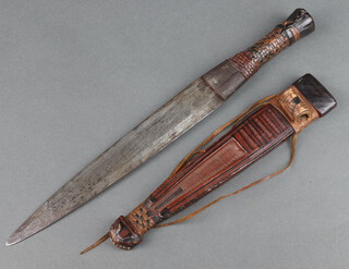 An Eastern dagger with 23cm double edged blade contained in a leather scabbard 