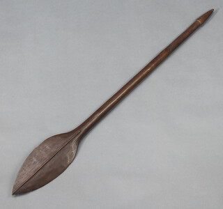 A carved Eastern hardwood paddle with leaf shaped head 113cm l x 13cm w 