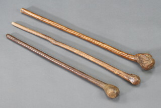 A carved hardwood knobkerrie 64cm, a carved hardwood club 71cm and a shalaylee 73cm  