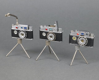 Three Cont-Lite Japanese table lighters in the form of cameras and tripods, the base marked Made in Occupied Japan (2 are a/f) 