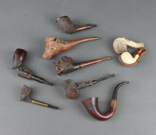 A 19th Century pipe in the form of a soldiers head and 7 other pipes