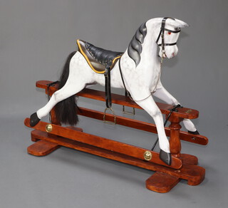 An antique dappled grey rocking horse complete with bridle and saddle the base marked Lucky, restored 2006, 100cm h x 138cm h x 55cm d