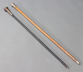 An ebony walking cane with floral cloisonne terminal together with a malacca cane with white metal terminal  