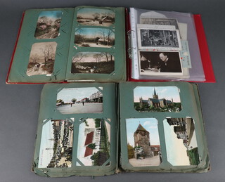 A red postcard album of black and white postcards including White Star Liner Titanic, other postcards of London scenes, coloured postcards of children and animals, a postcard album of black and white and coloured postcards of seaside resorts and a red ring bound album including a theatre programme "Gone With the Wind", various postcards and 2 editions of "Their Majesty's Crowns" Coronation 1937