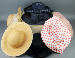 A lady's Marcelle George pink hat, a Fenwick green hat, a Mallard red and white polkadot hat, a black hat, a blue hat, 3 straw hats and a hat box 