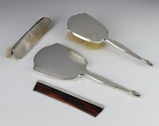 A silver 4 piece engine turned brush set comprising hand mirror, hair brush, clothes brush and comb, Birmingham 1964