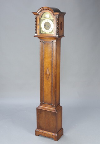 A 1930's chiming longcase clock with 19cm arched dial, silvered chapter ring and Roman numerals contained in an oak case with sliding hood 162cm h x 36cm w x 22cm d 