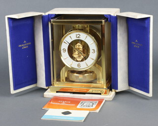 A Jaeger Lecoultre gilt metal cased Atmos clock - Atmos Classic V, 22cm h x 18cm w x 13.5cm d, complete with instructions, guarantee dated 15 January 1972 and box  