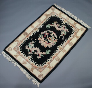 A black and white ground Chinese rug decorated dragons 177cm x 122cm
