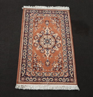 A machine made pink and blue ground Persian style rug 146cm x 91cm 