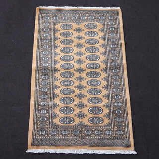 A gold and black ground Bokhara rug with 24 octagons to the centre 163cm x 93cm 