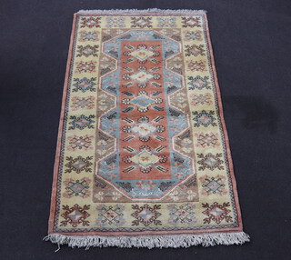 A Turkish Caucasian style yellow and blue ground rug with 5 diamonds to the centre 208cm x 122cm 
