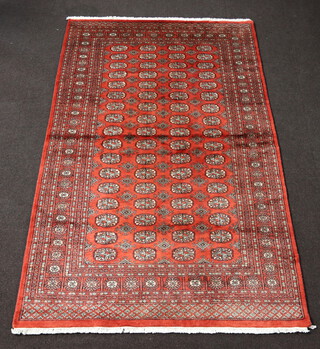 A red ground Bokhara rug with 68 octagons to the centre 250cm x 156cm 