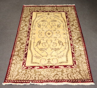 A wool and silk red, white and brown ground Eastern rug with all-over geometric design to the centre 275cm x 183cm 