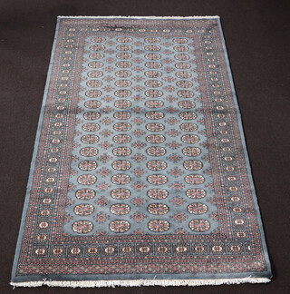 A blue ground Bokhara rug with 68 octagons to the centre 244cm x 152cm 