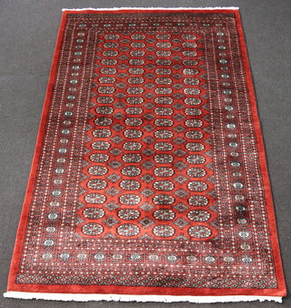 A burnt orange ground Bokhara with 72 octagons to the centre 248cm x 158cm 
