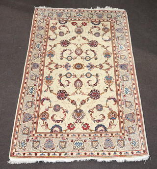 A North West Persian white ground part silk rug with floral decoration to the centre with a 4 row border 210cm x 134cm 