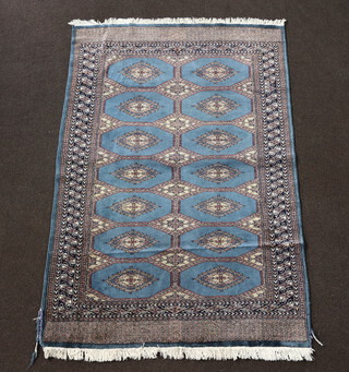 A blue and white ground Bokhara rug with 14 stylised diamonds to the centre within a multi row border 189cm x 137cm 