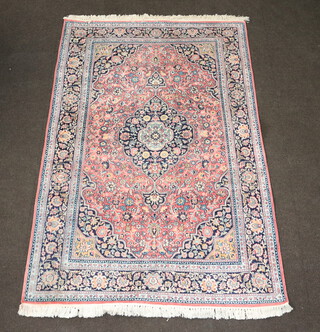 A North West Persian pink, white and blue ground silk rug with central medallion 203cm x 134cm 