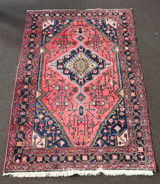A blue and red ground North West Persian rug with central medallion within multi row border 207cm x 136cm  