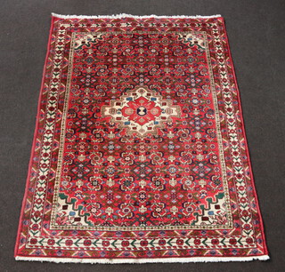 A red, blue and white ground Persian rug with central medallion 203cm x 149cm 
