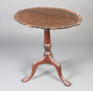 A 19th Century oval Chippendale style snap top wine table with pie crust edge, raised on a turned column and tripod base with egg and claw feet 74cm h x 76cm d w x 59cm d 