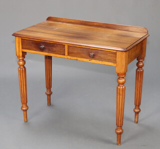 A 19th Century Gillows style mahogany side table with raised back fitted 2 drawers on turned and reeded supports 78cm x 90cm x 50cm 