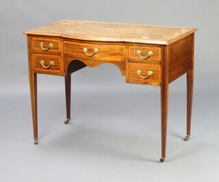 An Edwardian bleached and inlaid mahogany bow front writing table with brown leather inset writing surface fitted a 1 long and 4 short drawers, raised on square tapered supports 76cm h x 98cm w x 56cm d 