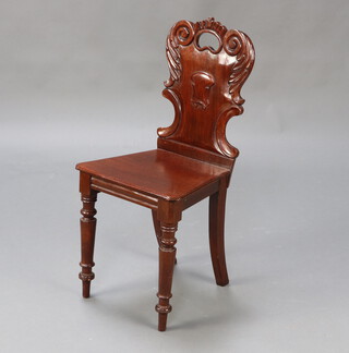 A Victorian carved mahogany hall chair with solid seat on turned supports 84cm h x 39cm w x 36cm d