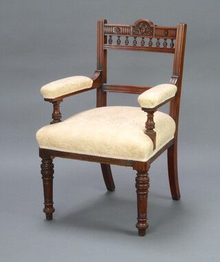 An Edwardian carved walnut bar back open armchair with bobbin turned decoration, upholstered arms and seat 96cm h x 61cm w x 54cm d (seat 27cm x 34cm) 