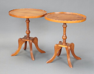 A pair of oval Georgian style yew wine tables, raised on pillar and tripod bases 54cm h x 46cm w x 39cm d (1 with ring mark)