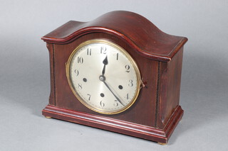A German 8 day chiming mantel clock with silvered dial and Arabic numerals contained in a mahogany arch shaped case 27cm x 33cm x 15cm 