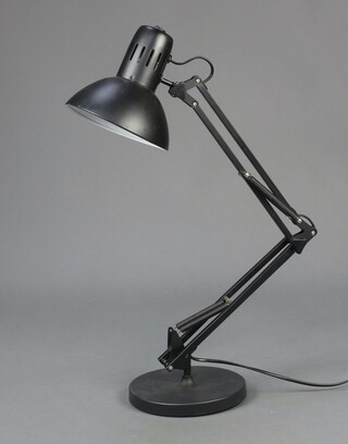 A black anglepoise lamp on a circular base 69cm x 18cm 
 