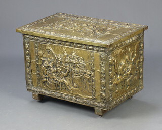 An embossed brass coal bin decorated Tavern scenes 38cm x 55cm x 35cm 